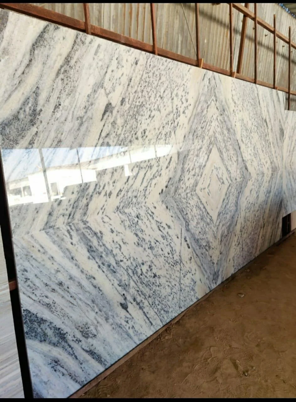 A large finished marble slab standing in the SAV Stonex warehouse