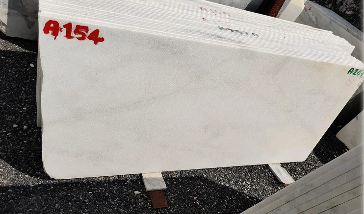 Ambaji White marble slabs stacked in the SAV Stonex yard